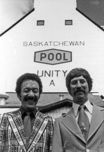 CFQC Radio co-hosts Wally Stambuck (left) and Denny Carr pose in front of Unity, Saskatchewan, grain elevator on Canada Day 1977.