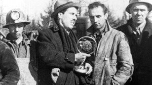 Reporter J. Frank Willis interviews mine with the rescue team at the Moose River mine cave-in, April 1936. He is speaking to more than 100 million people on radio stations across Canada, the U.S. and Britain. 