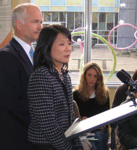 Jack Layton and Olivia Chow addressing journalists, including Alexis Dobranowski, during a policy announcement at Centennial College in January 2006.