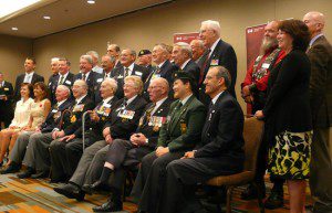 Ted Barris (seated right) joins 18 other recipients at a ceremony on July 27, 2011.