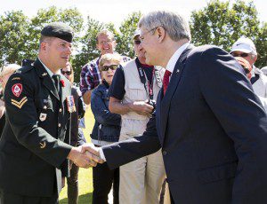 Prime Minister greets Oscar Trachmann, Canadian Forces veteran at Beny-sur-Mer cemetery, June 6, 2014. (Photo courtesy Deb Ransom)