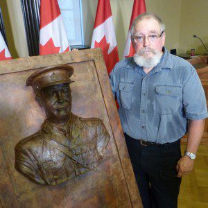 First responder now sculptor Tyler Briley and his relief of LCol Sam Sharpe.