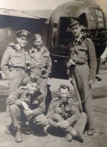 Halifax bomber crew pose at rear gun turret - navigator Alex McCracken at right.